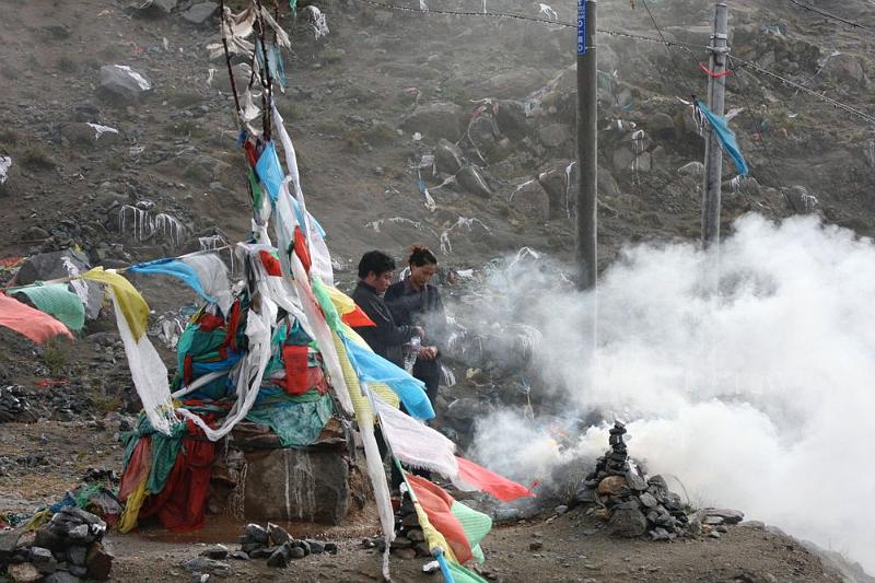 053 A local couple worships at the pass to Ganden.jpg
